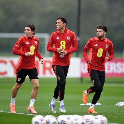 121025 - Wales Football Training - From left to right, Harry Wilson, Brennan Johnson and Neco Williams of Wales during a training session ahead of tomorrows World Cup qualifier match against Belgium