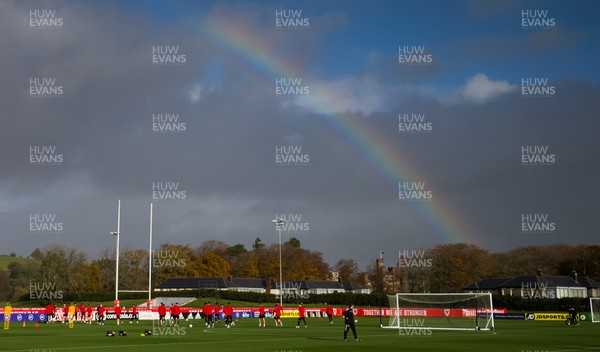 121121 - Wales Football Training Session - The Wales squad warm up under a rainbow during a training session ahead of the World Cup Qualifying match against Belarus
