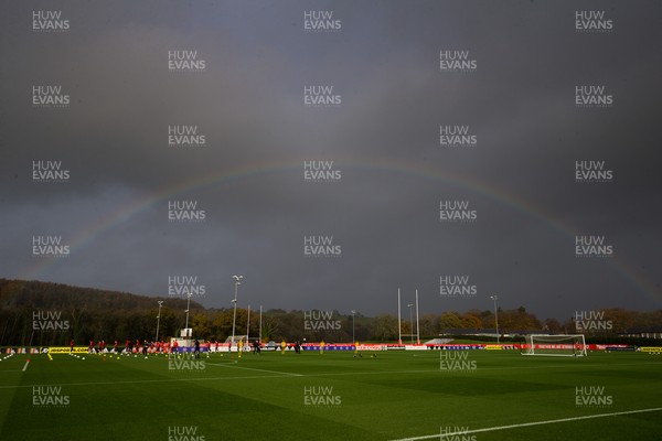 121121 - Wales Football Training Session - The Wales squad warm up under a rainbow during a training session ahead of the World Cup Qualifying match against Belarus