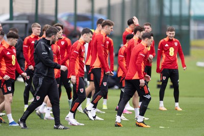 200324 - Wales Football Training Session - Wales players warm up during training session ahead of Wales’  Euro 2024 qualifying play-off semi-final against Finland