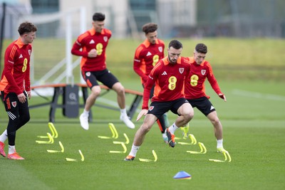 200324 - Wales Football Training Session - Wales players warm up during training session ahead of Wales’  Euro 2024 qualifying play-off semi-final against Finland