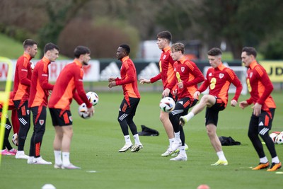 200324 - Wales Football Training Session - Wales players warm up during training session ahead of Wales’  Euro 2024 qualifying play-off semi-final against Finland