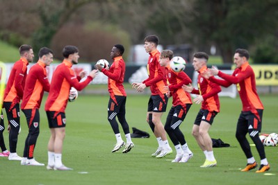 200324 - Wales Football Training Session - Wales players warm up during training session ahead of Wales’  Euro 2024 qualifying play-off semi-final against Finland