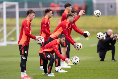 200324 - Wales Football Training Session - Wales players warm up during training session ahead of Wales’  Euro 2024 qualifying play-off semi-final against Finland