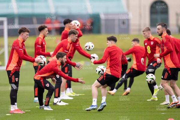 200324 - Wales Football Training Session - Wales players warm up during training session ahead of Wales’  Euro 2024 qualifying play-off semi-final against Finland