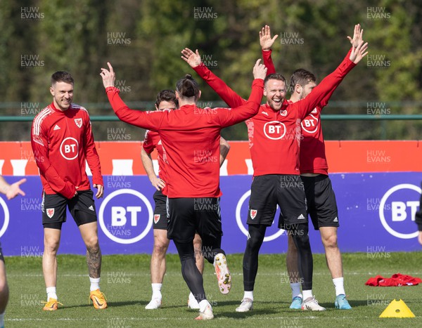 230322 Wales Football Training - Aaron Ramsey, Gareth Bale and Chris Gunter lead the celebrations during a Wales football training session ahead of the World Cup Qualifier play off semi final match against Austria