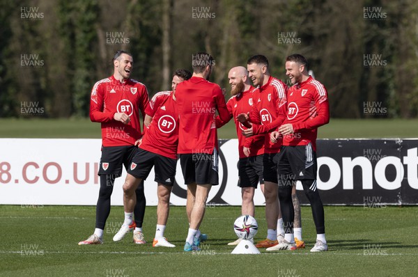 230322 Wales Football Training - Gareth Bale enjoys a joke with team mates during a Wales football training session ahead of the World Cup Qualifier play off semi final match against Austria
