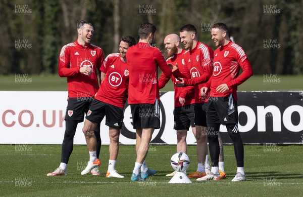 230322 Wales Football Training - Gareth Bale enjoys a joke with team mates during a Wales football training session ahead of the World Cup Qualifier play off semi final match against Austria
