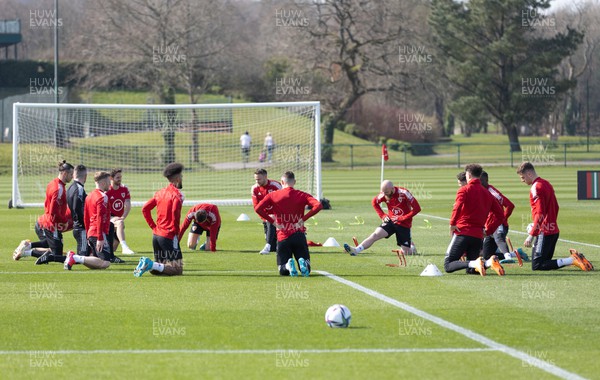 230322 Wales Football Training - Wales squad members warm up during a Wales football training session ahead of the World Cup Qualifier play off semi final match against Austria