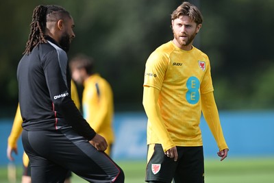 230926 - Wales Football Training - Wales coach, Ashley Williams and Wes Burns during training ahead of their upcoming Nations League match against Portugal