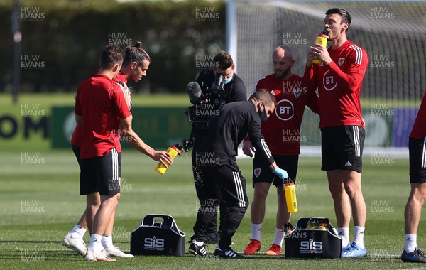 310820 - Wales Football Training - Gareth Bale sprays water on a member of staff during training ahead of their UEFA Nations League game against Finland