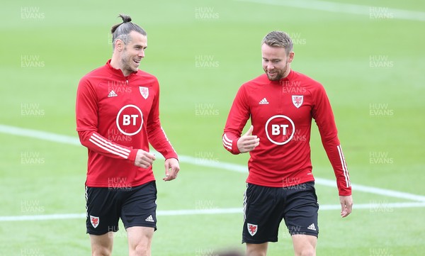 310821 - Wales Football Training - Gareth Bale shares a joke with Chris Gunter during a Wales training session ahead of their friendly against Finland and World Cup qualifying matches against Belarus and Estonia