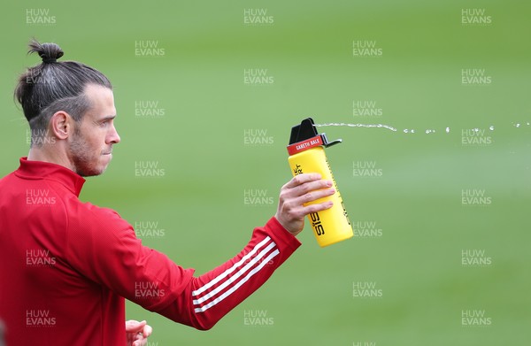 310821 - Wales Football Training - Gareth Bale sprays his team mates with water during a Wales training session ahead of their friendly against Finland and World Cup qualifying matches against Belarus and Estonia