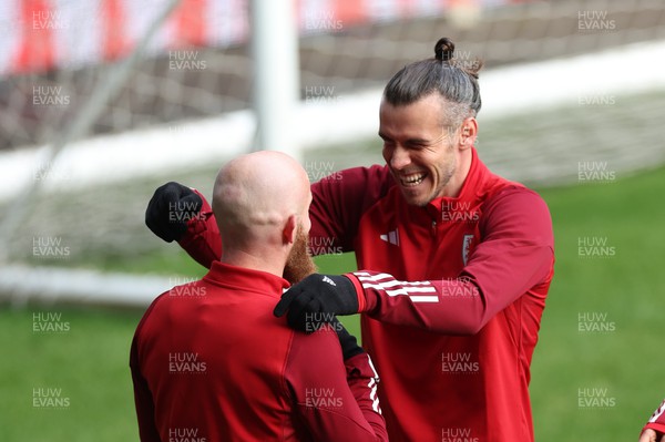 151122 - Wales Football Training Session - Gareth Bale of Wales shares a joke with Jonny Williams of Wales during the final Wales training session and send off as the team depart for the FIFA World Cup in Qatar