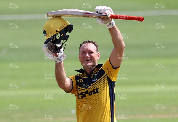 310722 - Wales National County v Glamorgan - One Day Tour Match - Colin Ingram of Glamorgan celebrates hitting his century alongside Billy Root