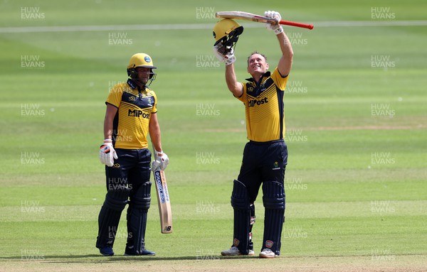 310722 - Wales National County v Glamorgan - One Day Tour Match - Colin Ingram of Glamorgan celebrates hitting his century alongside Billy Root
