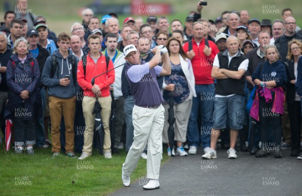 190914 - ISPS Handa Wales Open Golf 2014, Celtic Manor Resort, south Wales - England's Lee Westwood plays up the second after his ball ends up in the crowd during the second round of matches in the Wales Open 2014