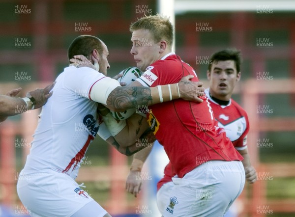 251012 -  Wales v England - Rugby League -     Craig Kopzack of Wales, right, is tackled by Gareth Hock of England  