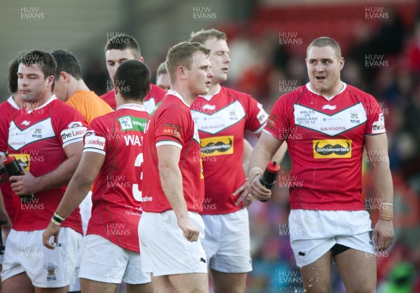 251012 -  Wales v England - Rugby League -     Craig Moss of Wales, centre, and the rest of the team look dejected after England score another try  