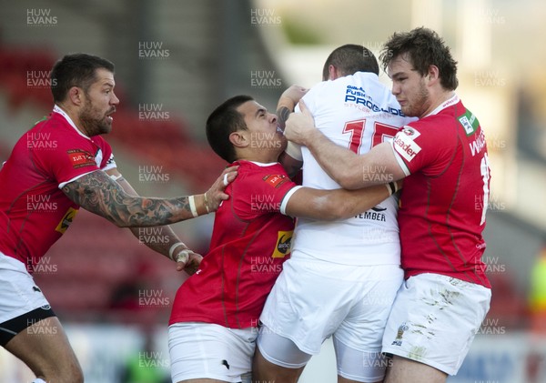 251012 -  Wales v England - Rugby League -     Jordan James, Mike Channing and Ben Evans of Wales combine to tackle Gareth Hock of England  