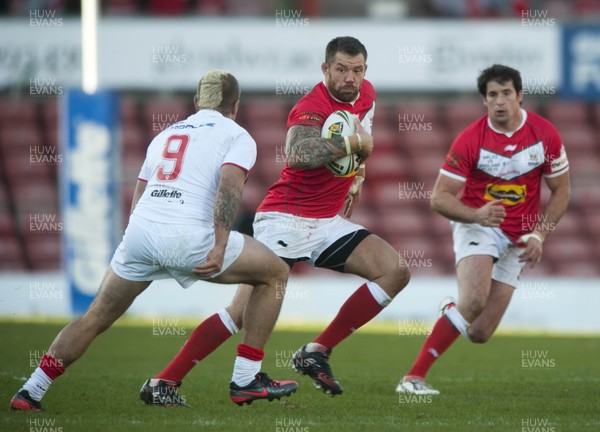 251012 -  Wales v England - Rugby League -     Jordan James of Wales, centre, runs to avoid the tackled by Michael McIlorum England  