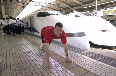040601 - Wales Rugby - Mark Jones lines up against the famous 'Bullet Train' at Tokyo station before the team left for Osaka