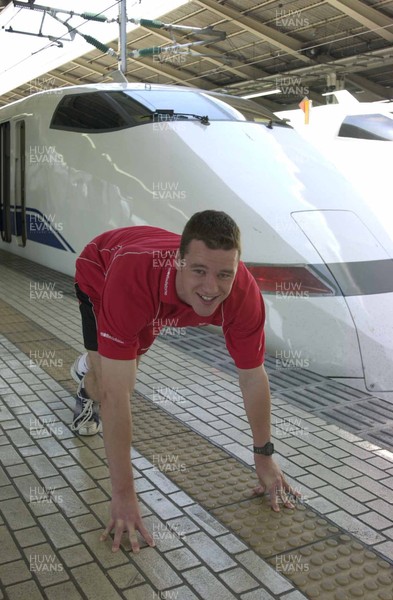 040601 - Wales Rugby - Mark Jones lines up against the famous 'Bullet Train' at Tokyo station before the team left for Osaka