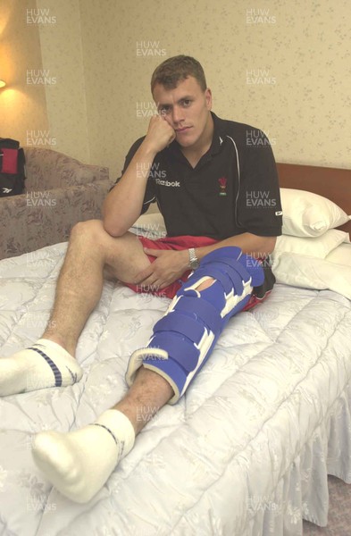 050601 - Wales Rugby Training - Wing Craig Morgan sits in his hotel room in Osaka with his injured leg strapped up which has ruled him out of the rest of the tour