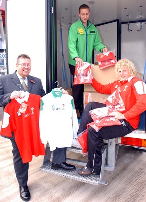 051103 - Wales' Duncan Jones, and WRU Commercial Manager Gwyn Thomas help Richard Forsyth from ASDA load up with Wales rugby jerseys to go on sale before the match against England on Sunday