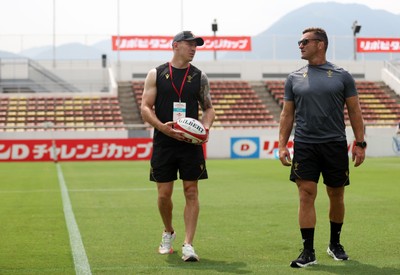 040725 - Wales Rugby Captains Run at Mikuni World Stadium ahead of the game against Japan - Josh Adams and Huw Bennett, Head of Physical Performance