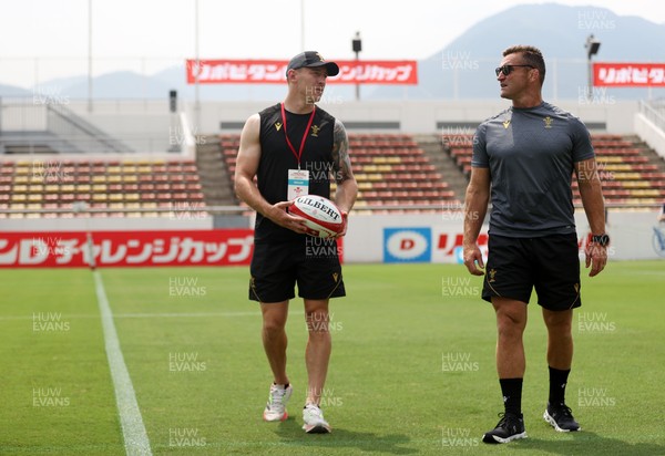 040725 - Wales Rugby Captains Run at Mikuni World Stadium ahead of the game against Japan - Josh Adams and Huw Bennett, Head of Physical Performance
