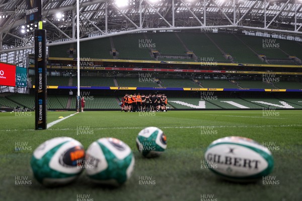 050326 - Wales Rugby Captains Run ahead of their Six Nations game against Ireland tomorrow evening - Wales team huddle in the Aviva Stadium