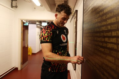 130326 - Wales Rugby Captains Run ahead of their last Six Nations game against Italy - Louie Hennessey puts his own name on the honours board in the stadium