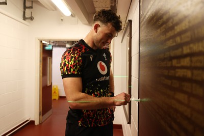 130326 - Wales Rugby Captains Run ahead of their last Six Nations game against Italy - Louie Hennessey puts his own name on the honours board in the stadium