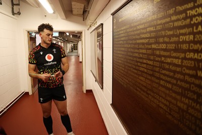 130326 - Wales Rugby Captains Run ahead of their last Six Nations game against Italy - Louie Hennessey puts his own name on the honours board in the stadium