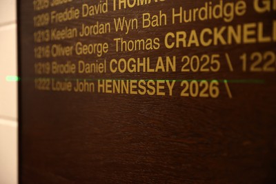 130326 - Wales Rugby Captains Run ahead of their last Six Nations game against Italy - Louie Hennessey puts his own name on the honours board in the stadium