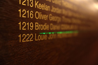130326 - Wales Rugby Captains Run ahead of their last Six Nations game against Italy - Louie Hennessey puts his own name on the honours board in the stadium