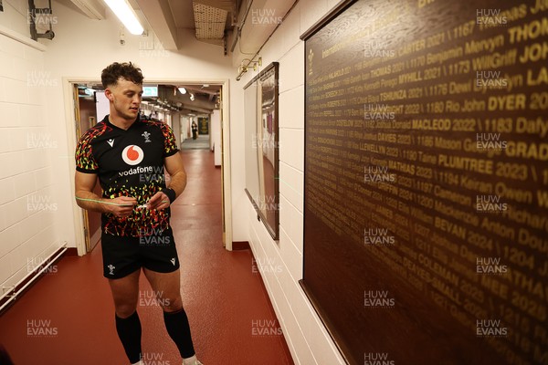 130326 - Wales Rugby Captains Run ahead of their last Six Nations game against Italy - Louie Hennessey puts his own name on the honours board in the stadium