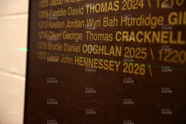 130326 - Wales Rugby Captains Run ahead of their last Six Nations game against Italy - Louie Hennessey puts his own name on the honours board in the stadium
