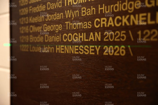 130326 - Wales Rugby Captains Run ahead of their last Six Nations game against Italy - Louie Hennessey puts his own name on the honours board in the stadium