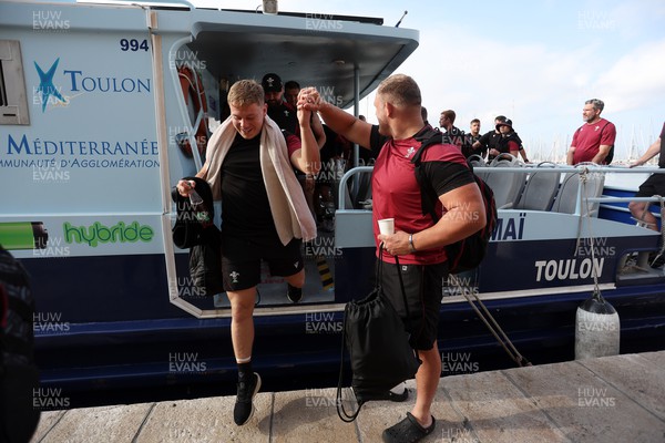 131023 - Wales Rugby Captains Run - The team take the The Toulon M�tropole Bateau-Bus, the fastest form of public transport to training - Corey Domachowski helps Sam Costelow off the boat
