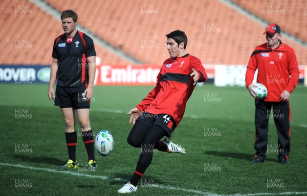 17.09.11 - Wales Rugby Captains Run - James Hook kicks as Rhys Priestland and kicking coach Neil Jenkins look on during training. 