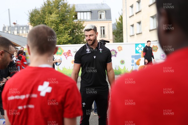 041023 - Picture shows the Wales Rugby Team visiting IME Le Rondo Croix Rouge in Versailles, a school for children with disabilities - Johnny Williams with the pupils playing catch