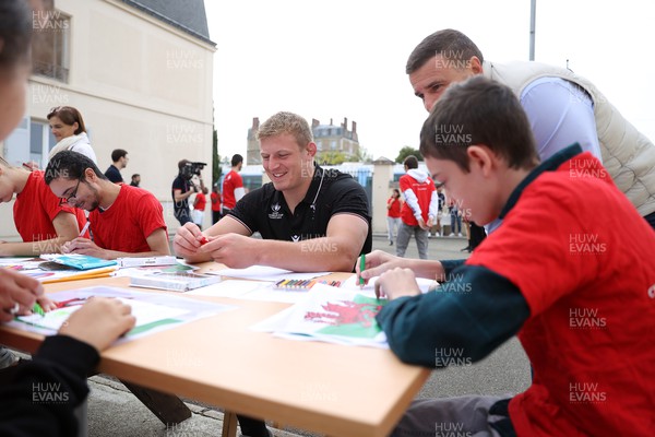041023 - Picture shows the Wales Rugby Team visiting IME Le Rondo Croix Rouge in Versailles, a school for children with disabilities - Jac Morgan speaks to the pupils
