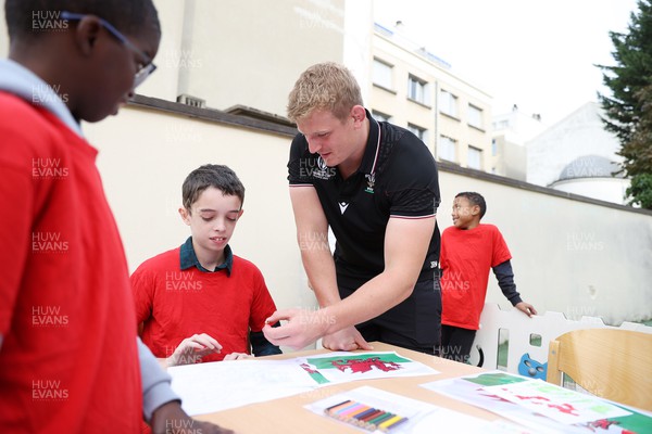 041023 - Picture shows the Wales Rugby Team visiting IME Le Rondo Croix Rouge in Versailles, a school for children with disabilities - Jac Morgan with the pupils