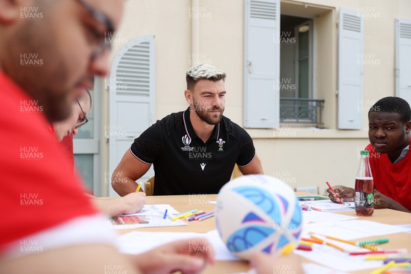 041023 - Picture shows the Wales Rugby Team visiting IME Le Rondo Croix Rouge in Versailles, a school for children with disabilities - Johnny Williams with the pupils