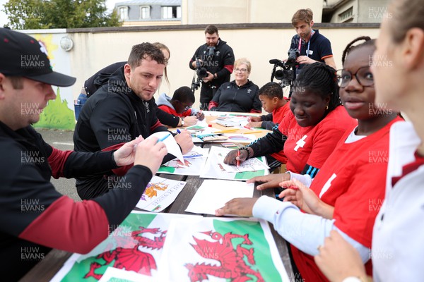 041023 - Picture shows the Wales Rugby Team visiting IME Le Rondo Croix Rouge in Versailles, a school for children with disabilities - Ryan Elias with the pupils