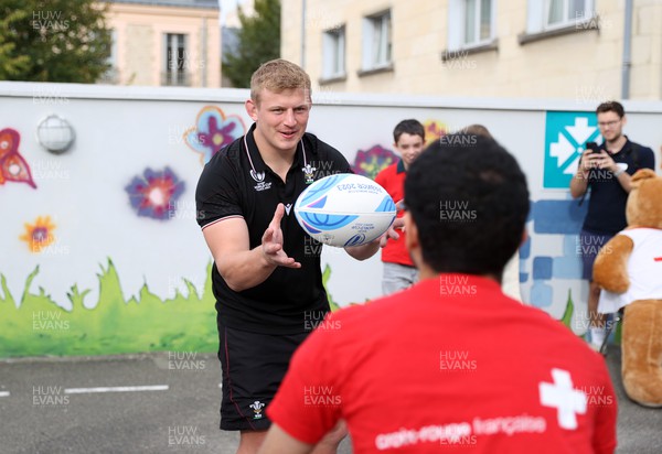 041023 - Picture shows the Wales Rugby Team visiting IME Le Rondo Croix Rouge in Versailles, a school for children with disabilities - Jac Morgan with pupils