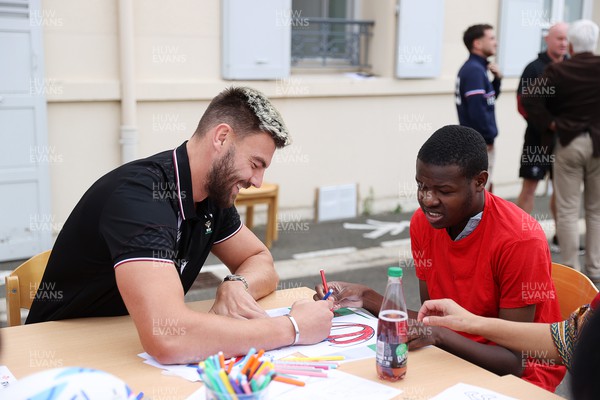 041023 - Picture shows the Wales Rugby Team visiting IME Le Rondo Croix Rouge in Versailles, a school for children with disabilities - Johnny Williams with pupils