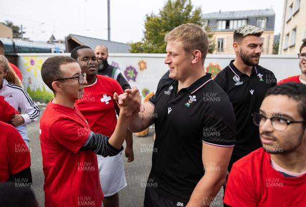 041023 - Picture shows the Wales Rugby Team visiting IME Le Rondo Croix Rouge in Versailles, a school for children with disabilities - Jac Morgan with pupils